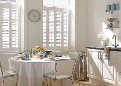 Café style shutters cover the lower portion of the window only.