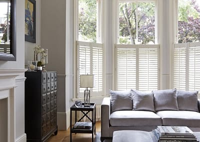Café style shutters cover the lower portion of the window only.